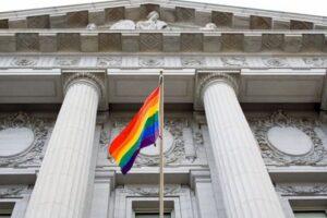 A rainbow flag flutters outside the city hall in San Francisco, celebrating LGBTQIA+ rights and community